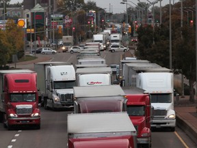 - Trucks back up for kilometres on Huron Church Road in Windsor, Ontario on October 22, 2013.   A computer glitch with U.S. Customs caused major delays Tuesday with trucks entering the United States.  (JASON KRYK/The Windsor Star)