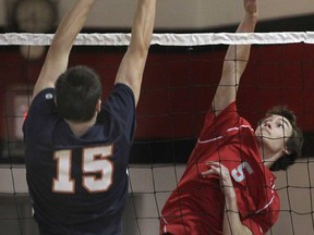 Sandwich's Nathan Hesman, left, goes up for a block against Brennan's Eric Kirby during WECSSAA volleyball action Tuesday, Oct. 22, 2013, in Windsor.  (DAN JANISSE/The Windsor Star)