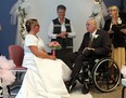 Jardine Joyce (centre) leads Stephanie Powell and Ron Clarke as they are wed during a ceremony at the Windsor Regional Hospital Ouellette Campus in Windsor on Thursday, October 31, 2013. On Friday Clarke will under go his third surgery since being diagnosed with a brain tumor.         (TYLER BROWNBRIDGE/The Windsor Star)