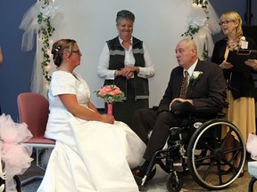 Jardine Joyce (centre) leads Stephanie Powell and Ron Clarke as they are wed during a ceremony at the Windsor Regional Hospital Ouellette Campus in Windsor on Thursday, October 31, 2013. On Friday Clarke will under go his third surgery since being diagnosed with a brain tumor.         (TYLER BROWNBRIDGE/The Windsor Star)