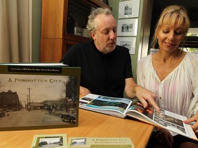 Chris Edwards and Elaine Weeks are photographed with their latest book A Forgotten City at their home in Windsor. (TYLER BROWNBRIDGE / The Windsor Star)