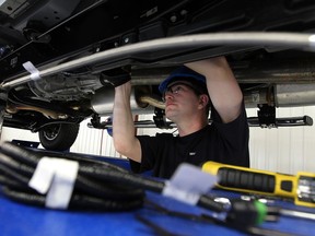 Aaron Doey works on a Ford F250 during the grand opening of Westport in Windsor on Wednesday, October 16, 2013. Westport will convert Ford trucks to run on both gas and natural gas.        (TYLER BROWNBRIDGE/The Windsor Star)