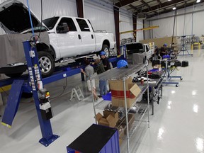 Trucks are seen on the work line at the grand opening of Westport in Windsor on Wednesday, October 16, 2013. Westport will convert Ford trucks to run on both gas and natural gas.        (TYLER BROWNBRIDGE/The Windsor Star)