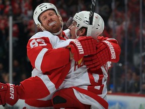 Detroit's Johan Franzen, left, celebrates with Justin Abdelkader after Franzen scored the winning goal against the Colorado Avalanche in the third period at Pepsi Center on October 17, 2013 in Denver. The Red Wings defeated the Avalanche 4-2.  (Doug Pensinger/Getty Images)
