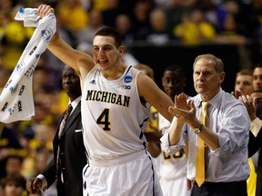 Michigan's Mitch McGary, left, and head coach John Beilein celebrate during the NCAA men's basketball tournament at at The Palace March 21, 2013 in Auburn Hills, Mich. The Wolverines open the season Nov. 8 against UMass-Lowell. (Gregory Shamus/Getty Images)