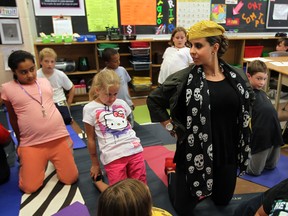 Teacher Natasha Feghali and her pupils perform yoga routine during French class at Eastwood Public School. (NICK BRANCACCIO / The Windsor Star)