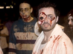 Windsor Zombie Walk participant Brendan Armstrong keeps an eye out on Ouellette Avenue on Oct. 5, 2013. (Joel Boyce / The Windsor Star)