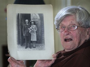 Kay May, 99, shows off a photo from her wedding day, Friday, Nov. 8, 2013, at her home near Harrow. She married John May on  July 18, 1942. At 99-years-old, the native of England is one of the oldest war brides in Canada. (DAN JANISSE/The Windsor Star)