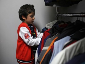 Hadi Abouel El Joud, 6, browses through a rack of winter jackets at Coats for Kids at the Unemployed Help Centre, Saturday, Nov. 2, 2013.  (DAX MELMER/ The Windsor Star)