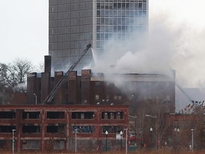 Detroit fire crews work to put out a fire in an abandoned apartment complex on East Jefferson, Saturday, Nov. 23, 2013.  Smoke from the fire had earlier blown over parts of Windsor.  (DAX MELMER/The Windsor Star)