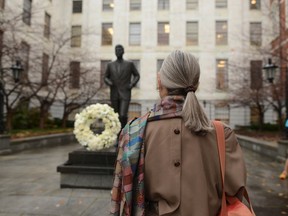 A woman looks at the John F. Kennedy statue at the State House Friday, Nov. 22, 2013 in Boston, Mass. Kennedy, born in Brookline Massachusetts, was killed 50 years ago by Lee Harvey Oswald in Dallas Texas in 1963. (Photo by Darren McCollester/Getty Images)