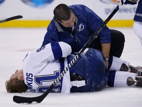 Tampa Bay's Steven Stamkos, left, is attended to on the ice after breaking his leg against the Boston Bruins. (AP Photo/Elise Amendola)