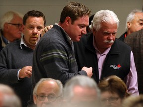 MPPs Taras Natyshak and Percy Hatfield, huddle as hundreds of concerned area residents jammed Kin Club Auditorium at Vollmer Centre to attend an information meeting regarding the possible removal of thoracic cancer surgery from the area November 12, 2013.  (Nick Brancaccio/The Windsor Star)