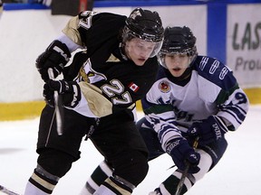 LaSalle's Ben Hanus, left, is checked by Owen MacDonald of St. Marys  at the Vollmer Centre. (TYLER BROWNBRIDGE/The Windsor Star)