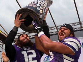 Tecumseh's Pawel Kruba, left, and Beau Landry raise the OUA Yates Cup after their win over the Queen's Gaels in London. (THE CANADIAN PRESS/Dave Chidley)