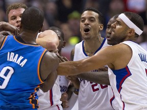 Los Angeles's Matt Barnes, second from the right, and Oklahoma City's Serge Ibaka, left, battle in Los Angeles Friday. (AFP PHOTO/Robyn Beck)