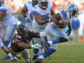 Detroit's Reggie Bush, right, breaks away from Chicago's James Anderson at Soldier Field. (Photo by Jonathan Daniel/Getty Images)