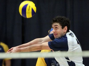 Windsor's Blase Wasser sets the ball in front of Greg Simone against the Ryerson Rams at the St. Denis Centre. (NICK BRANCACCIO/The Windsor Star)