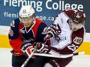 Windsor's Josh Ho-Sang, left, checks former Spitfire Michael Clarke of the Petes Friday in Peterborough. (Courtesy of Jessica Nyznik)