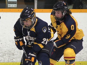 Windsor's Erinn Noseworthy, left, is checked by Marlee Fisher of Queen's in February at South Windsor Arena.  (DAN JANISSE/The Windsor Star)