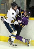 Lancers forward Drew Palmer, left, checks Western's Steve Reese at Windsor Arena in February. (TYLER BROWNBRIDGE/The Windsor Star)