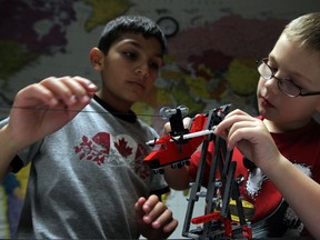 Nabil Barchale, left, and Jake Fox,   members of VerifastBots First Lego Robotics Team are competing in the FIRST Lego Robotics Nature's Fury 2013 Challenge.  In photo, students prepare a Lego cargo plane launch, part of their comprehensive project at CentreLine on Morton Drive Tuesday November 19, 2013. (NICK BRANCACCIO/The Windsor Star)