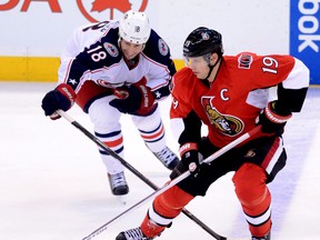 Former Spitfire Jason Spezza, right, is checked by R.J. Umberger of the Blue Jackets in Ottawa. (THE CANADIAN PRESS/Sean Kilpatrick)