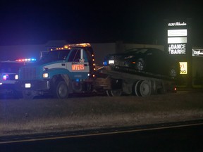 A Windsor tow truck loads a vehicle from an accident that occurred on the E.C. Row Expressway between Central Avenue and Jefferson Boulevard in Windsor, Ont., Saturday, Nov. 16, 2013. (JOEL BOYCE/The Windsor Star)