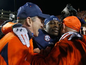 Auburn's Chris Davis, left, celebrates with coaching staff after scoring the winning touchdown to defeat the Alabama Crimson Tide 34-28 at Jordan-Hare Stadium Saturday in Auburn. (Photo by Kevin C. Cox/Getty Images)