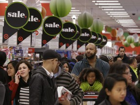 People shop at a Target store in Colma, Calif., Thursday, Nov. 28, 2013. Instead of waiting for Black Friday, which is typically the year's biggest shopping day, more than a dozen major retailers opened on Thanksgiving day this year. (AP Photo/Jeff Chiu)