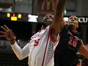 Windsor's Quinnel Brown, left, finishes a layup against Brampton's Cedric Moodie during NBL of Canada action Sunday at the WFCU Centre. (DAX MELMER/The Windsor Star)