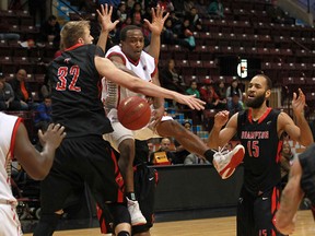 Windsor's Stefan Bonneau, centre, passes the ball to teammate Deandre Thomas, left, against the Brampton A's during NBL of Canada action Sunday at the WFCU Centre. Windsor won 93-77. (DAX MELMER/The Windsor Star)
