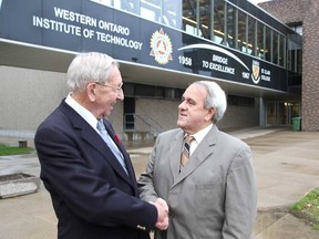 Western Ontario Institute of Technology's last principal, Charlie Jackson, left, shakes St. Clair College president John Strasser's hand during a dedication ceremony held at the college's south campus on Saturday, November 2, 2013. A walkway connecting the main building on campus to the Ford Centre of Excellence in Manufacturing was named after the W.O.I.T., St. Clair College's predecessor. (REBECCA WRIGHT/ The Windsor Star)