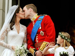 In this file photo, Prince William, Duke of Cambridge and Catherine, Duchess of Cambridge kiss on the balcony of Buckingham Palace after getting married on April 29, 2011 in London. (Photo by John Stillwell - WPA/Getty Images)
