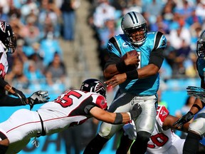 Paul Worrilow #55 of the Atlanta Falcons tries to tackle Cam Newton #1 of the Carolina Panthers during their game at Bank of America Stadium on November 3, 2013 in Charlotte, North Carolina.  (Streeter Lecka/Getty Images)