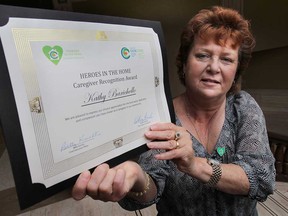 The Erie St. Clair CCAC Heroes in the Home caregiver recognition event was held Thursday, Nov. 7, 2013, at the Caboto Club in Windsor, Ont. More than 40 individuals were recognized for their efforts. Kathy Barichello, one of the recipients, displays her certificate. (DAN JANISSE/The Windsor Star)