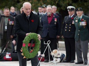 In this file photo, Minister of Veterans Affairs Julian Fantino places a wreath during a ceremony at the National War Memorial Tuesday, November 5, 2013 in Ottawa. (THE CANADIAN PRESS/Adrian Wyld)