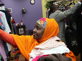 Ashura Namagajo, left, and her husband, Abdoul Mugalu, immigrants from the Democratic Republic of the Congo, pick up some winter clothes at Place Concorde in Windsor, Ont., Wednesday, Nov. 6, 2013.  (DAX MELMER/The Windsor Star)