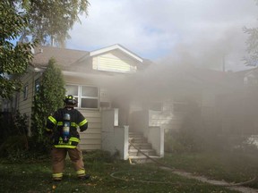 Windsor firefighters battle a house fire at 1604 Elsmere Ave., Sunday, Nov. 3, 2014.  No injures were reported.  Cause of the fire was unattended cooking.  (DAX MELMER/ The Windsor Star)