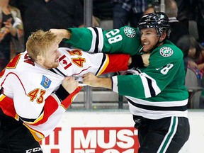 In this file photo, Dallas Stars left wing Lane MacDermid (28) and Calgary Flames defenseman Chris Breen (43) trade punches in the second period in Dallas Thursday, Oct. 24, 2013.  (AP Photo/The Dallas Morning News, Tom Fox)