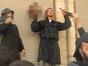 The victim's head is held aloft to a crowd in Aleppo. (Courtesy of Sky News)