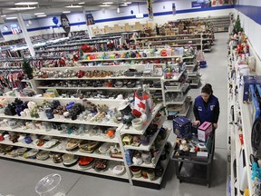 Goodwill Industries held a grand opening Wednesday, Nov. 27, 2013, at their new McDougall Street retail location in Windsor, Ont. Employee Amani Abouzeeni puts some last-minute items on the store shelves. It opens to the public Thursday, (DAN JANISSE/The Windsor Star)