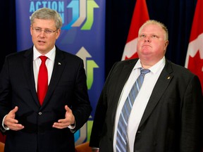 In the file photo, Prime Minister Stephen Harper speaks as Toronto Mayor Rob Ford, right, looks on, after announcing funding for new subways in Toronto, Sunday, Sept. 22, 2013. (The Canadian Press , Postmedia News)