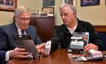 Ontario MPP Ernie Hardeman, left, and John Gignac, co-chair of the Hawkins-Gignac Foundation, look over carbon monoxide alarms in a handout photo. (THE CANADIAN PRESS/HO)