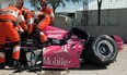 In this Oct. 6, 2013, file photo, safety team members work to remove driver Dario Franchitti, of Scotland, from his car after a crash during the second IndyCar Grand Prix of Houston auto race in Houston. The three-time Indianapolis 500 winner said Thursday, Nov. 14, 2013, that doctors have told him he can no longer race because of injuries sustained in an IndyCar crash last month. He fractured his spine, broke his right ankle and suffered a concussion in the Oct. 6 crash at Houston. (AP Photo/Juan DeLeon, File)