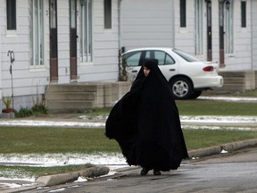 Members of the Jewish sect Lev Tahor are seen in a townhouse complex north of Chatham, Ont., on Tuesday, November 26, 2013. The group has settled in the area after fleeing Quebec.           (TYLER BROWNBRIDGE/The Windsor Star)
