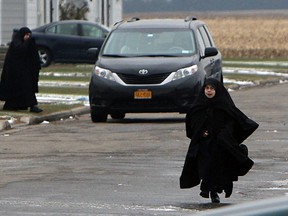 Members of the Jewish sect Lev Tahor are seen in a townhouse complex north of Chatham, Ont., on Tuesday, November 26, 2013. The group has settled in the area after fleeing Quebec.           (TYLER BROWNBRIDGE/The Windsor Star)