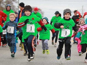 Kids take part in a small 200m run, called the Kids Dash, before the start of the Jingle Bell Run, which raises money for Community Living Essex County, in Essex, Sunday, Nov. 10, 2013.  (DAX MELMER/The Windsor Star)