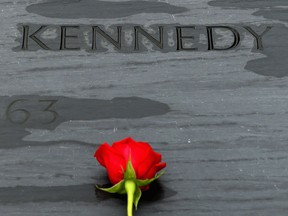 A rose left by family members sits on top of former U.S. President John F. Kennedy's grave marker at Arlington National Cemetery November 22, 2013 in Arlington, Virginia. Remembrance ceremonies will be held arcoss the United States today, the 50th anniversary of the assisination of President Kennedy. (Photo by Chip Somodevilla/Getty Images)