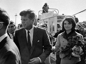 In this Nov. 22, 1963 file photo, President John F. Kennedy and his wife, Jacqueline Kennedy, arrive at Love Field airport in Dallas. (AP Photo/File)